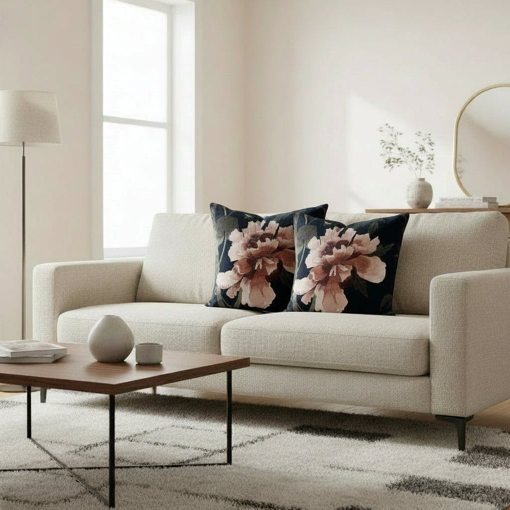 Two decorative pillows with floral patterns on a black background.