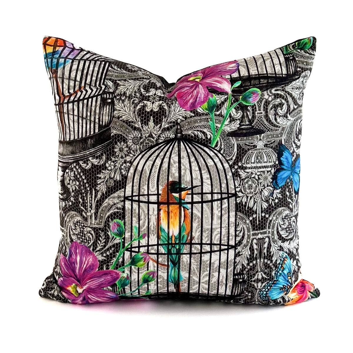 Decorative pillow with birdcage and floral design on a white background