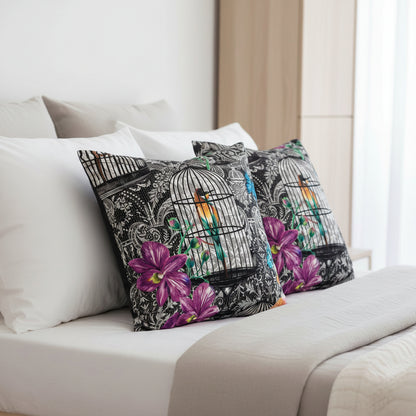 Decorative cushions with birdcage and floral designs sitting on white and neutral bedding 
