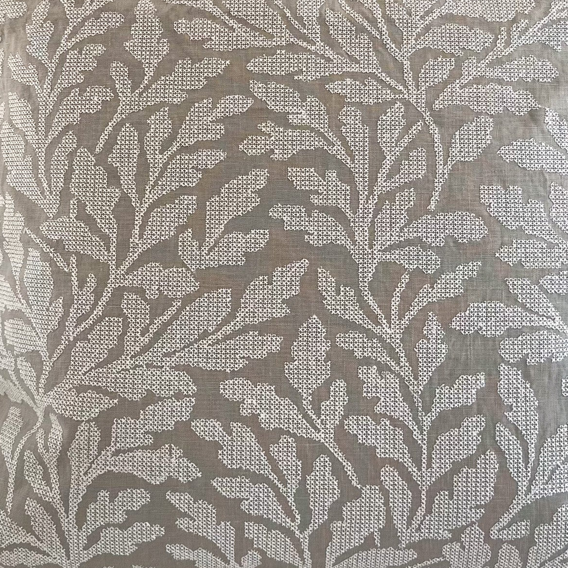 Closeup of decorative fabric with an embroidered leaf pattern 