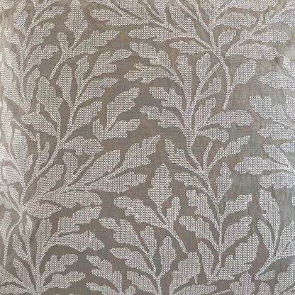 Closeup of decorative fabric with an embroidered leaf pattern 