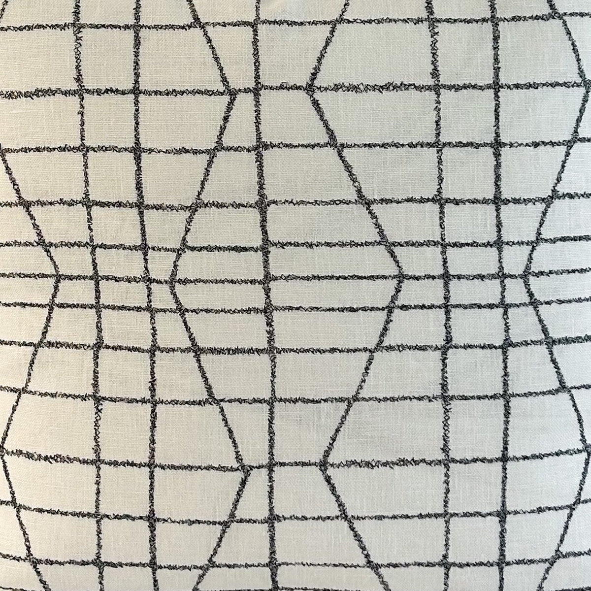 Decorative fabric with geometric black line pattern on a white background