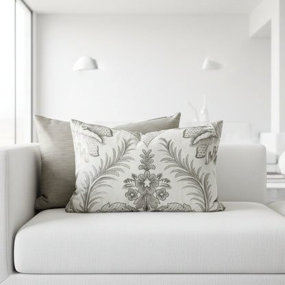 Decorative cushion with damask pattern on a white sofa in a white setting 