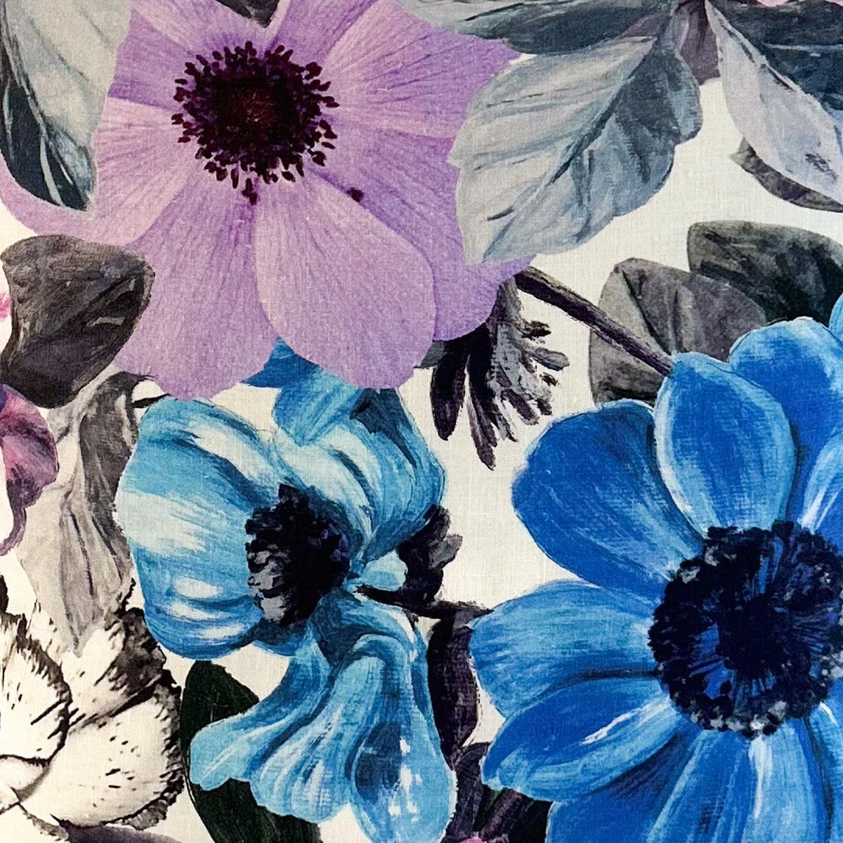Floral patterned fabric with blue and purple flowers on a white background