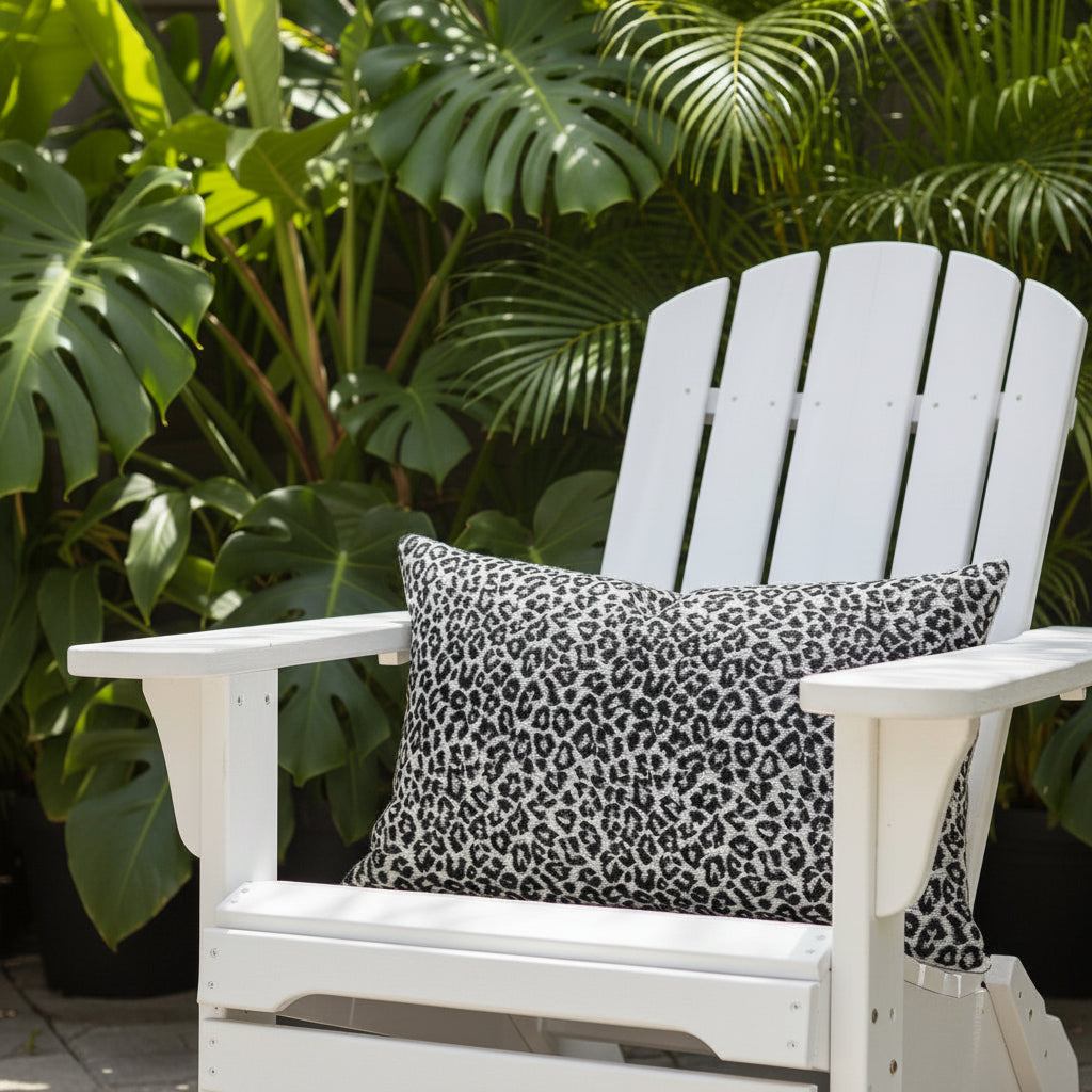 Tibet leopard print lumbar cushion sitting on a white outdoor chair 
