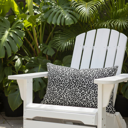 Tibet leopard print lumbar cushion sitting on a white outdoor chair 