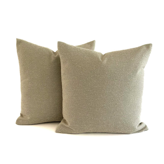 Two beige textured outdoor cushions on a white background