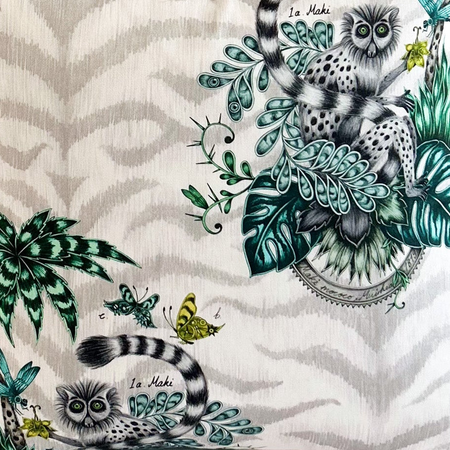 Decorative fabric with animal and nature-themed patterns on a white background