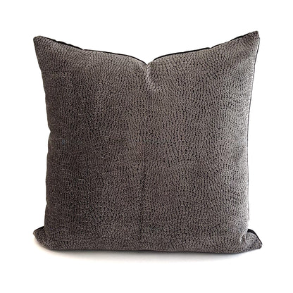Textured grey cushion on a white background