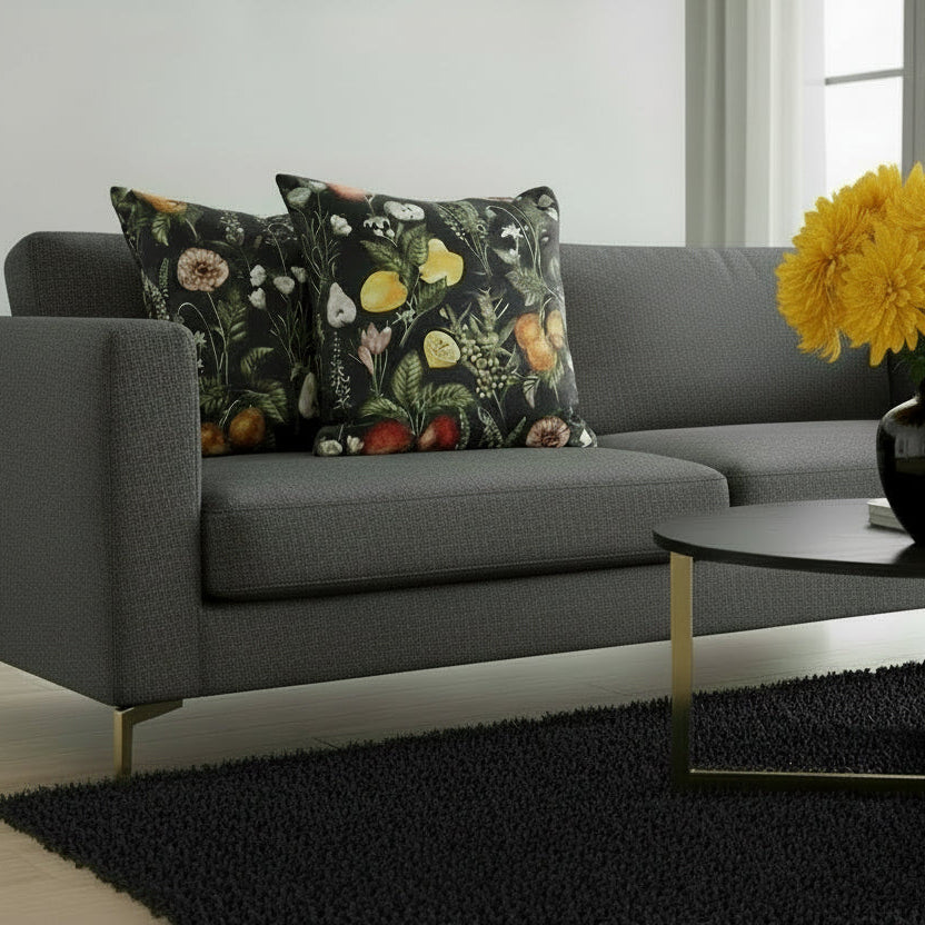 Gray sofa with floral-patterned cushions in a living room setting.