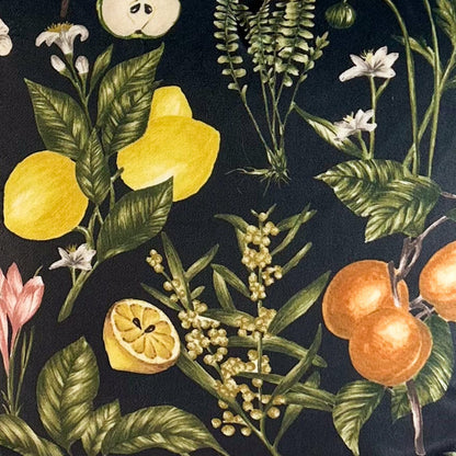 Decorative fabric with a botanical pattern featuring fruits and flowers on a black background.