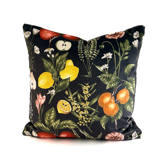 Decorative cushion with a colourful botanical and fruit pattern on an ebony black background