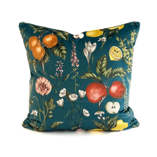 Decorative cushion with fruit and floral pattern on a teal background