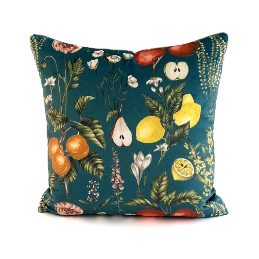 Decorative cushion with fruit and floral pattern on a teal background