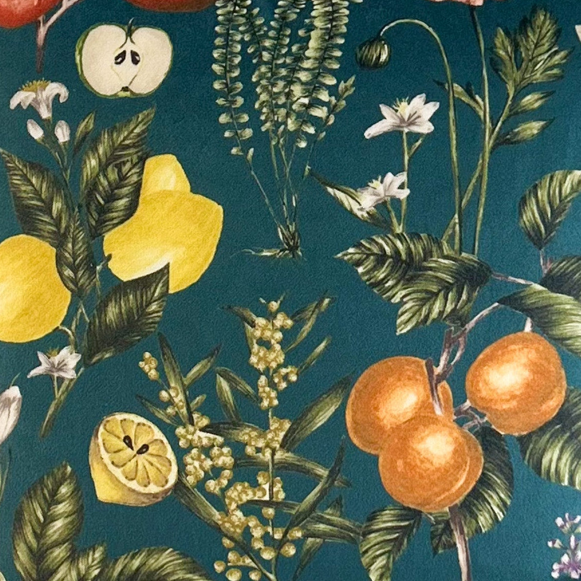 Decorative fabric with fruit and floral pattern on a teal background