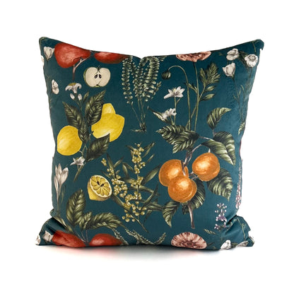 Decorative cushion with fruit and floral pattern on a teal background