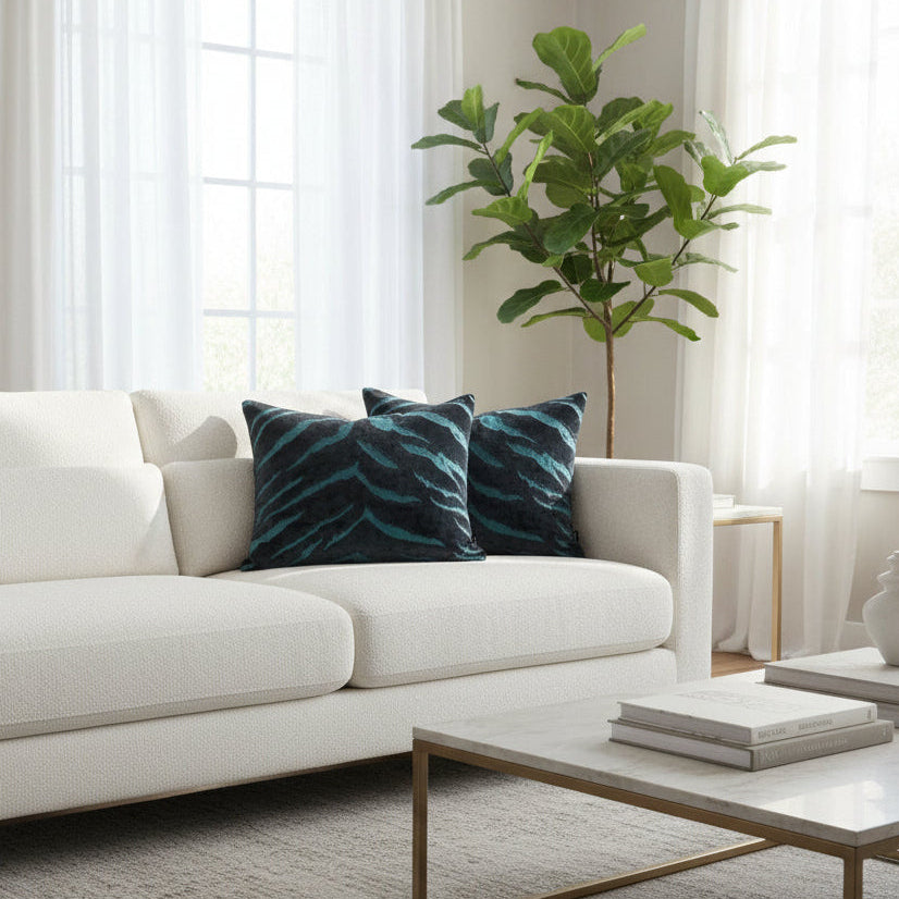 White sofa with blue cushions on a white boucle Sofa in a bright living room