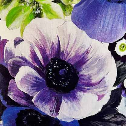 Closeup on floral fabric with purple and white flowers on a white background