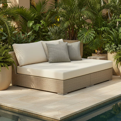 Outdoor patio furniture with cushions by a pool, surrounded by potted plants.
