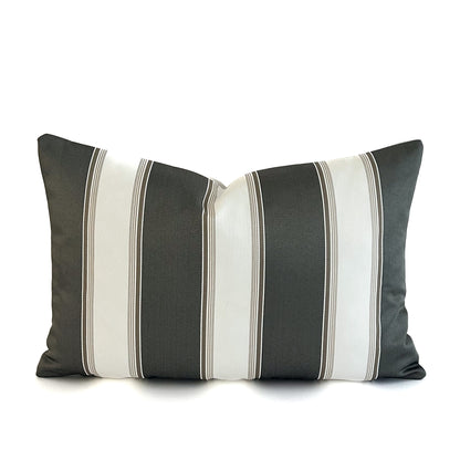 Striped cushion with black, grey, and white colours on a white background