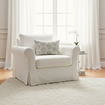 Decorative pillow with a sea urchin pattern on a white loose cover chair 