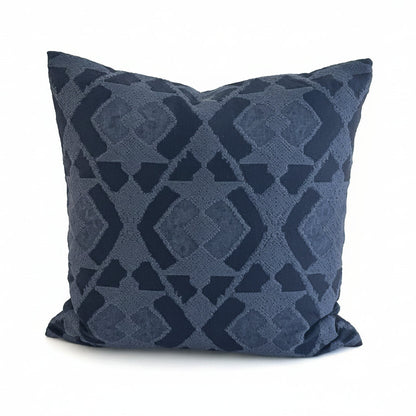 Navy blue cushion with geometric pattern on a white background